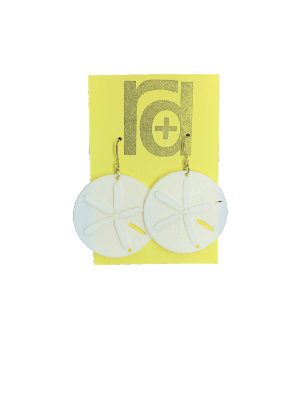 Two white earrings on a yellow earring card. The earrings look like sand dollars with a star burst patten that is raised from he surface.