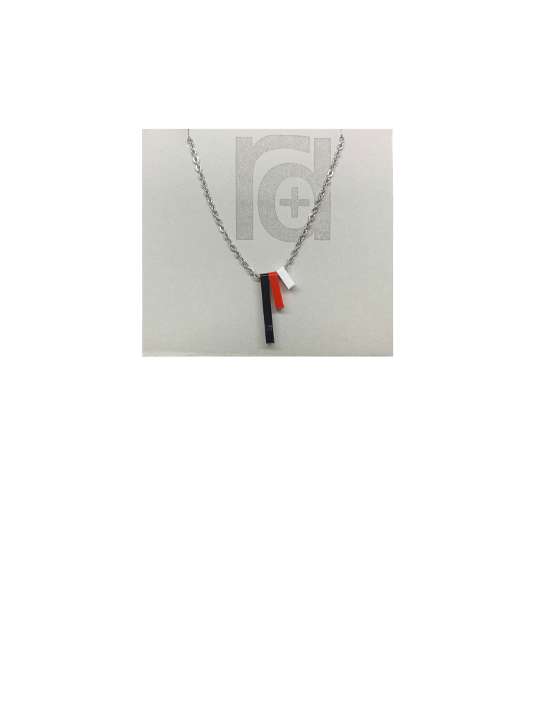 Pictured on a grey card is a R+D 3D printed necklace. There are three skinny pendants hanging from the chain. One is black, one is red, one is white. When the pendants are turned to the side, the customized words or names are visible. 