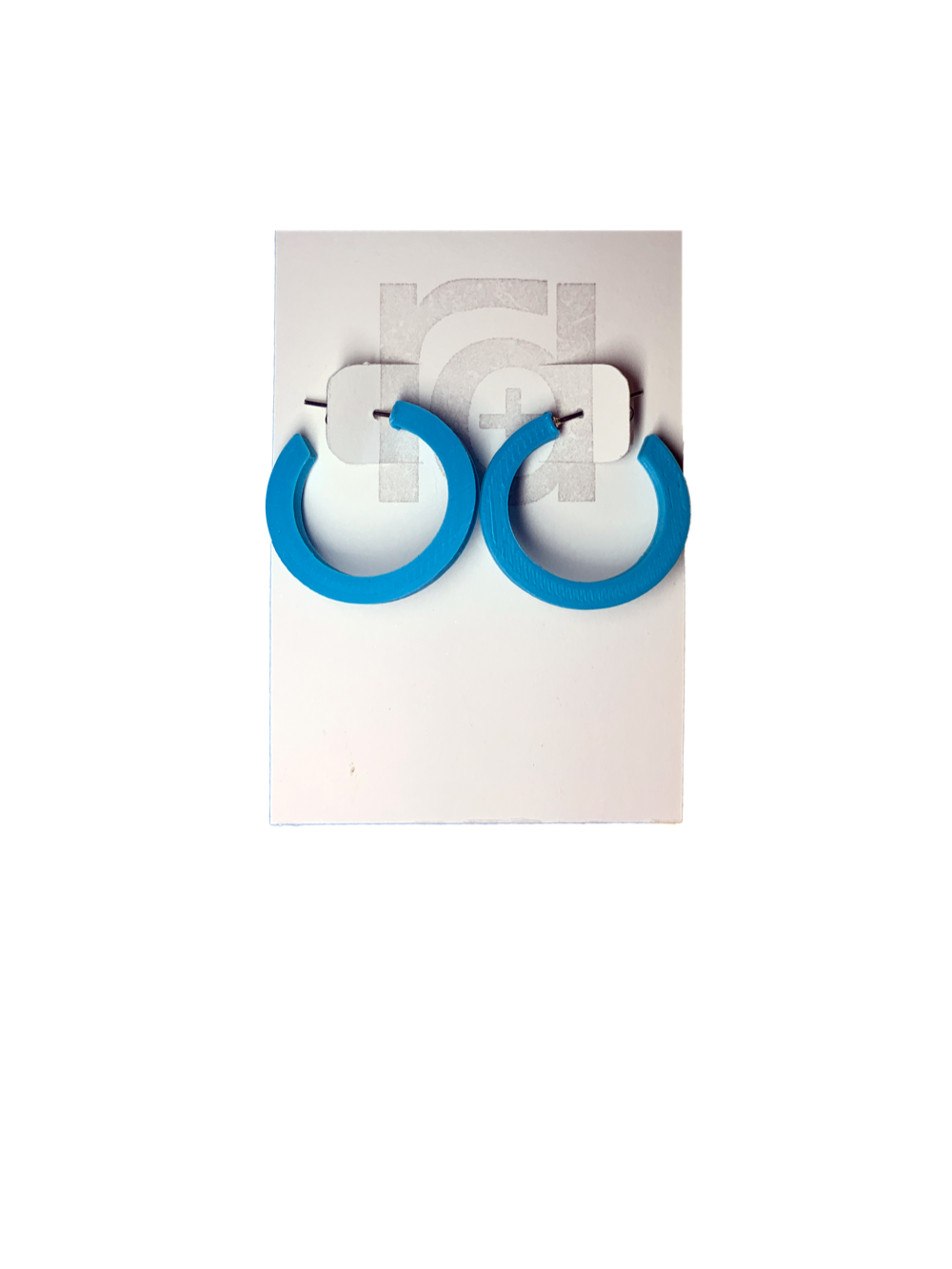 On a white R+D earring card are two chunky hoops. They are printed in an eco friendly teal color.