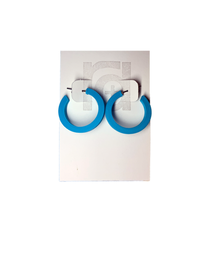 On a white R+D earring card are two chunky hoops. They are printed in an eco friendly teal color.