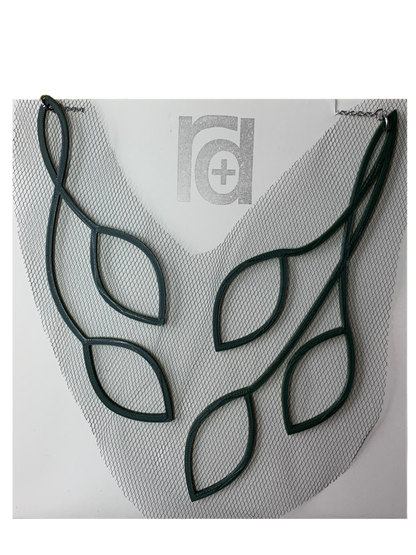 Shown on cream paper packaging, this 3D printed necklace has vines that twist to leaves in a elegant way. They are printed in a sustainable olive green filament with a black tulle fabric embedded.