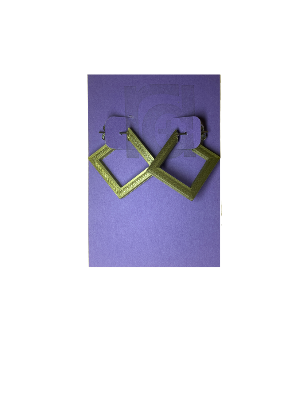 On a bight purple R+D card are two 3D printed earrings. They are hoops that are in the shape of squares. These are printed in a shiny gold.