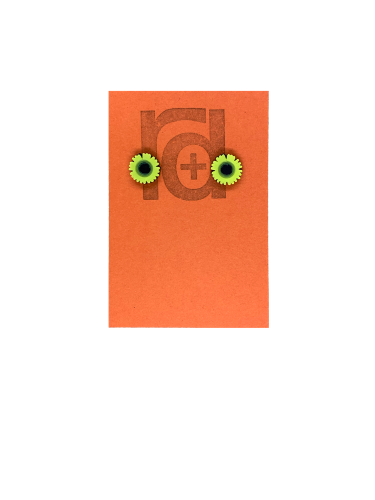 On a orange earring tag are two small and detailed  R+D studs. They are  shaped as sunflowers with black centers and bright yellow petals all around.