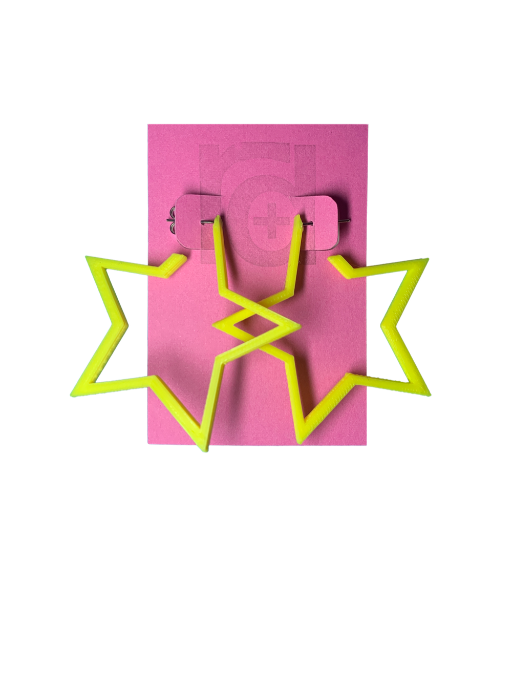 On a bright pink card are two R+D earrings. The earrings are yellow star hoops that are 3D printed with a plant based filament. 