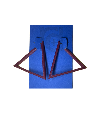 Hanging off of a blue R+D earring card are two 3D printed earrings. They are hoops that are in the shape of a triangle. These earrings are printed in a eco friendly deep red merlot.