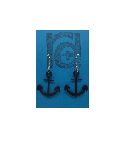 Two earrings hang on a blue earring card. The earrings are 3D printed in a plant based black filament. They are shaped like anchors. 