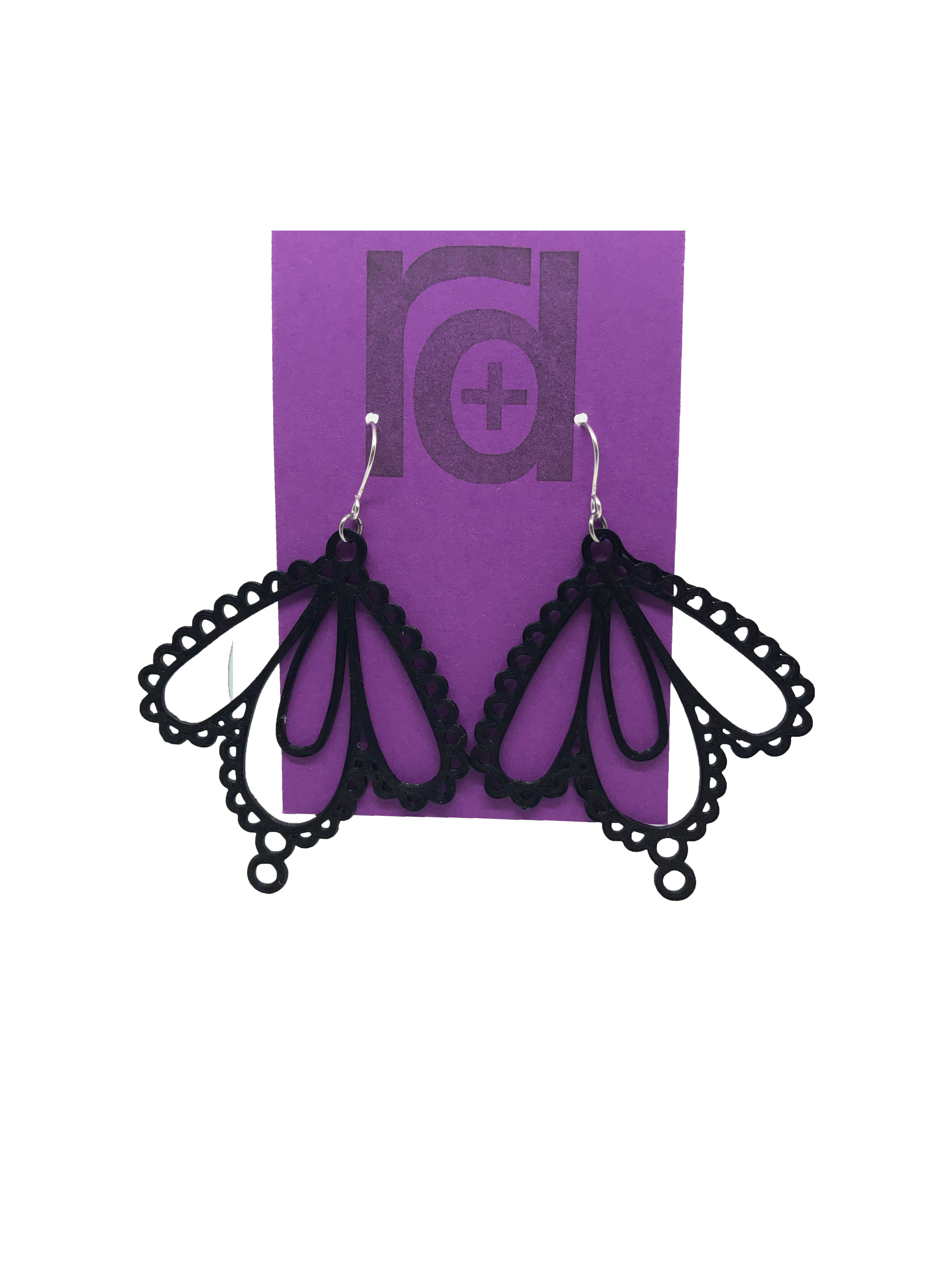 Two earrings on a purple earring card: they have three teardrop shapes and are reminiscent to lace. These 3D printed earrings are made with a black sustainable filament.  