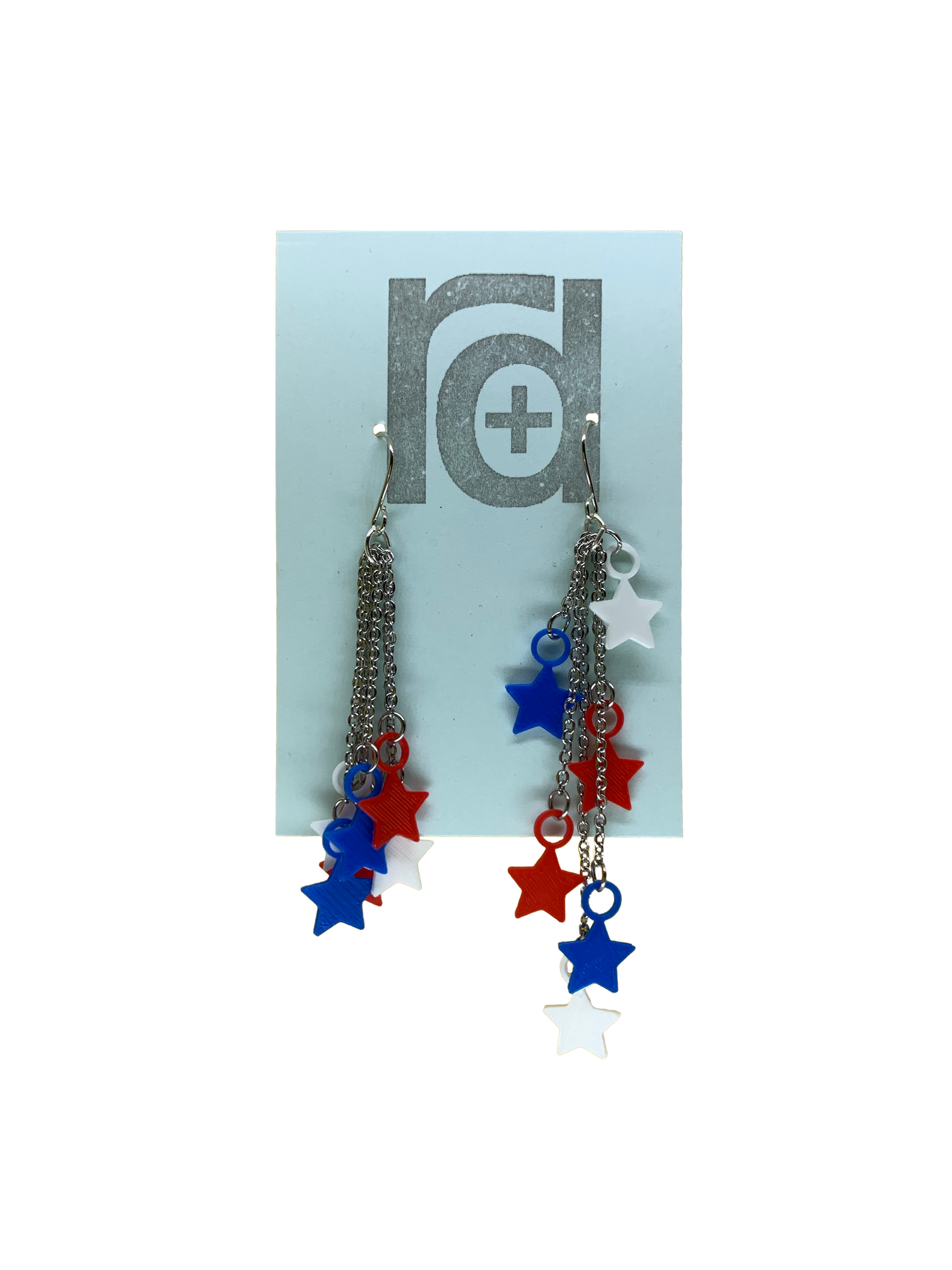 On a light blue earring card are two earrings. They have red, white, and blue stars that hang at the end of chains. The stars can be pulled to hang all at one length (shown on the left earring) or at various lengths (shown on the right earring). 