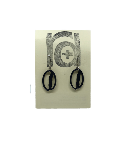 Shown on a light tan earring card are two earrings that are shaped like coffee beans. 