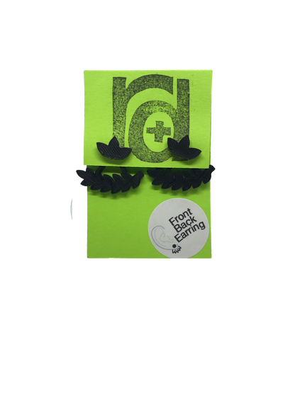 Shown on a bright green earring card are two R+D earrings. They are front back earrings (earring jackets) that have a cluster of three leaves on the stud. The piece that fits behind the ear is a leafy bough or vine that curves with the shape of one's earlobe. These eco friendly 3D printed studs are shown in black.