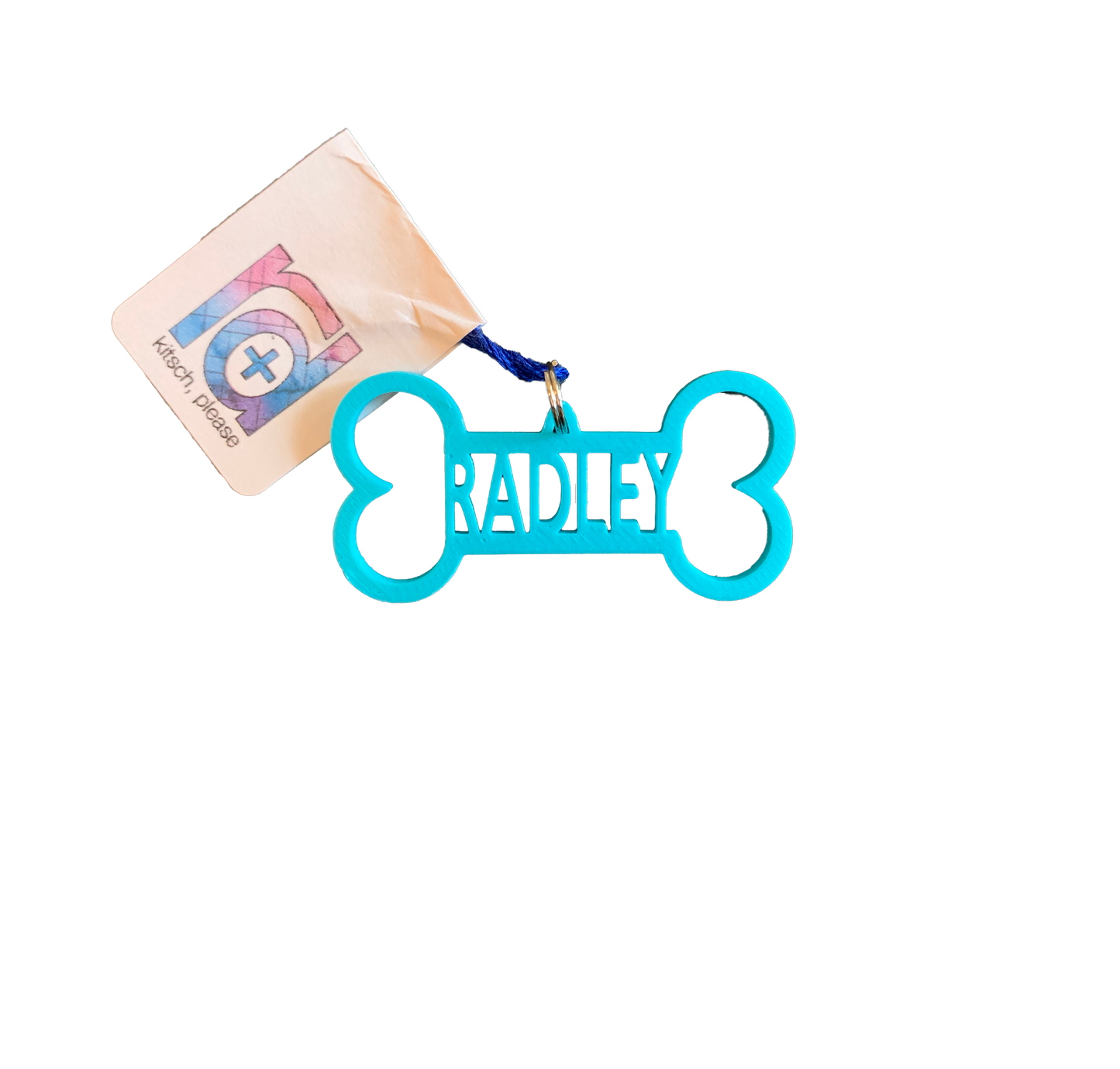 A bright teal dog bone tag is pictured. It is 3D printed and has the name Radley in the center. It can be customized to any pet name and to 15 other colors. 