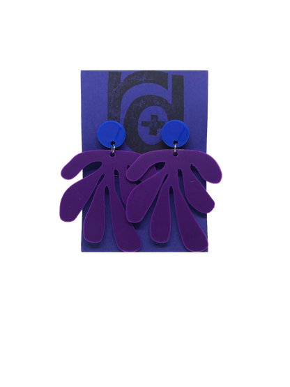 Shown on a bright blue R+D earring card, these earrings have a circlar piece at the top linked to an abstract shape based on Matisse's cut out work. This set is shown in Blue and purple plant based filament. 