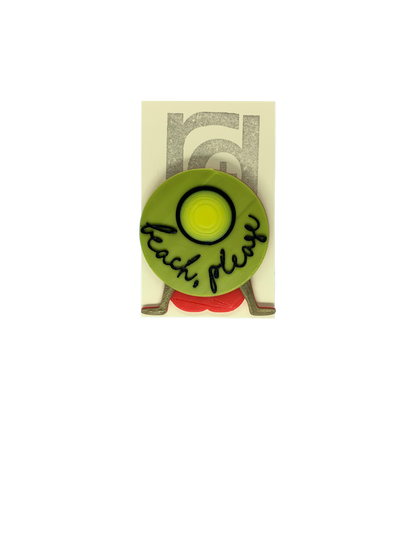 Shown on a cream colored card, this 3D printed pin shows someone sitting and relaxed back on their hands wearing  a red bathing suit and a large yellow hat that obstructs most of their body. The hat reads, beach, please in cursive.