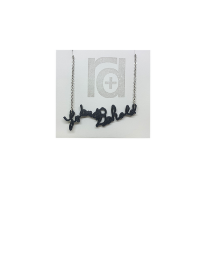Shown on a white necklace card is a necklace with a 3D printed pendant. The pendant is a handwriting.