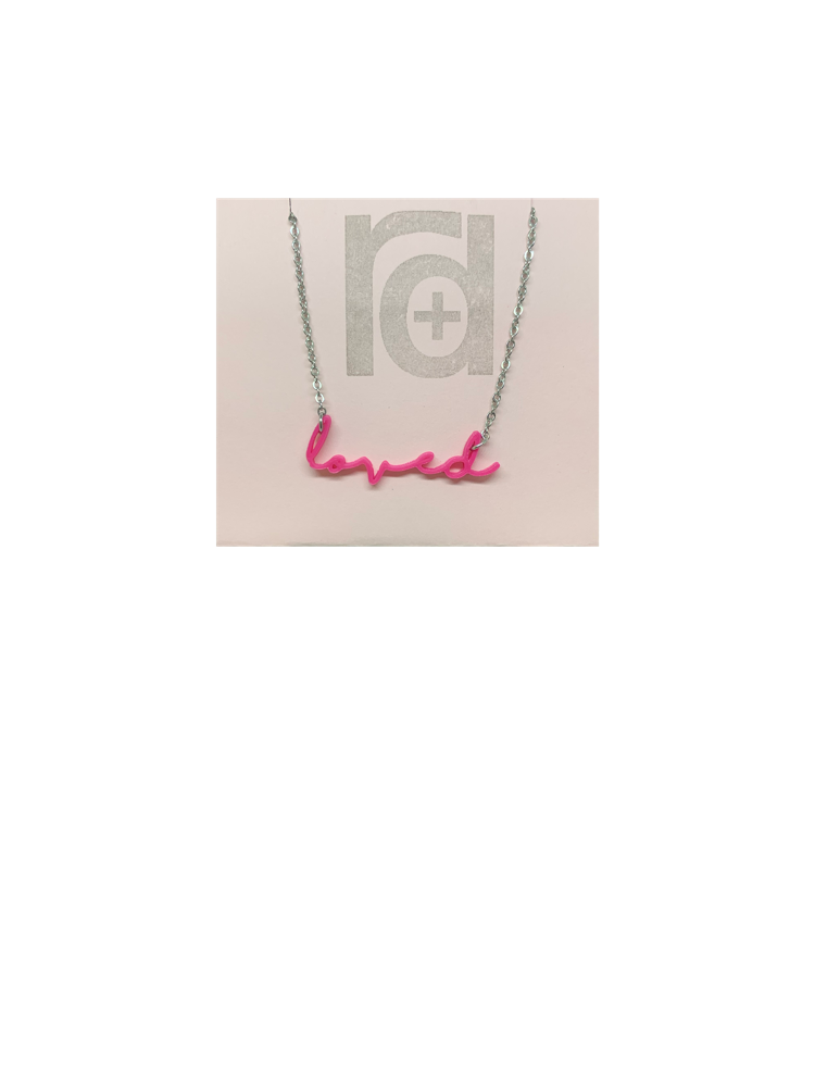 On a necklace card is a 3D printed necklace in hot pink. It is a modern cursive that says loved and can be customized to other names or words.