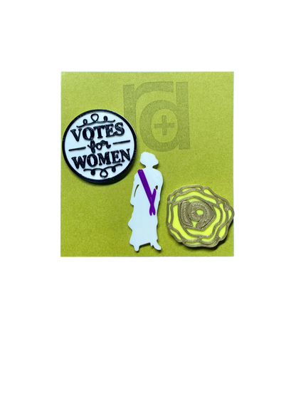 Shown on a green R+D card are a set of three 3D printed pins. The first on the left is a white circle with a black outline and words saying "Votes for Women". The next is a silhouette of a woman from the 1920s. Aside from the silhouette, there is a purple sash. The third pin is a yellow rose, which was worn in support of the movement. The petals are all outlined in gold and in the center is the number 19 for the 19th amendment. 